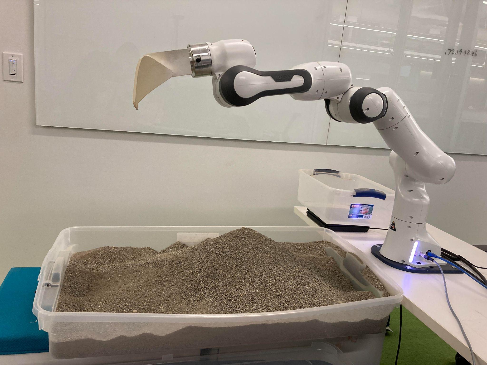 Excavation experiment platform with robot arm and material bin